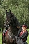 Frau streichelt Friese / woman is fondling friesian horse